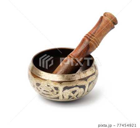 copper singing bowl and wooden mallet isolated on white background. Musical instrument for meditation, relaxation 77454921