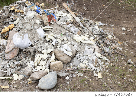 Pile of construction waste on the grass Pile of construction waste on the grass 77457037