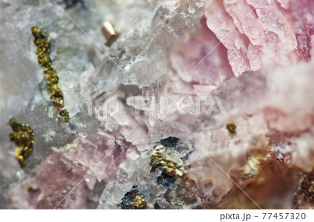 Pink crystals Rhodochrosite with particles of Pyrite. Natural  texture of mineral for background. Beautiful background and wallpaper. Macro. 77457320