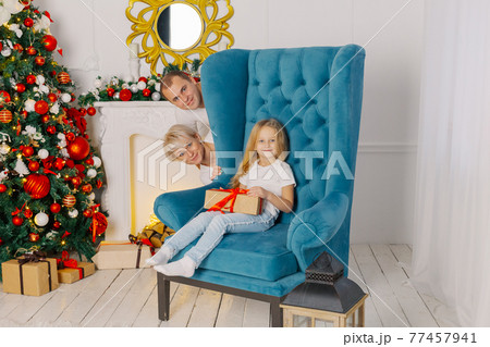 Beautiful young happy and cheerful family on an Beautiful young happy and cheerful family on an 77457941