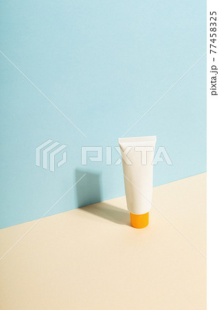 White tube of sunscreen on blue background. Sun Protection. Copy space White tube of sunscreen on blue background. Sun Protection. Copy space 77458325
