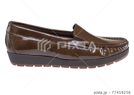 Brown women's patent leather low-soled shoes with a tread, on a white background Brown women's patent leather low-soled shoes with a tread, on a white background 77459256