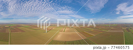 Panoramic aerial photo of a wind farm in Germany with blue sky and light clouds Panoramic aerial photo of a wind farm in Germany with blue sky and light clouds 77460575