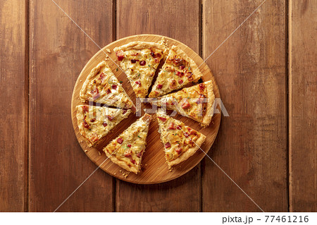 A quiche, shot from the top on a dark rustic wooden background 77461216