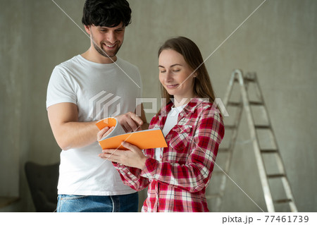 Family couple discussing a renovation of a home with color palette.  77461739