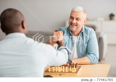 Multiracial family playing board games, father with son at home during covid-19 lockdown Multiracial family playing board games, father with son at home during covid-19 lockdown 77461765