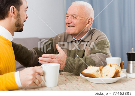 Elderly father and son breakfast Elderly father and son breakfast 77462805