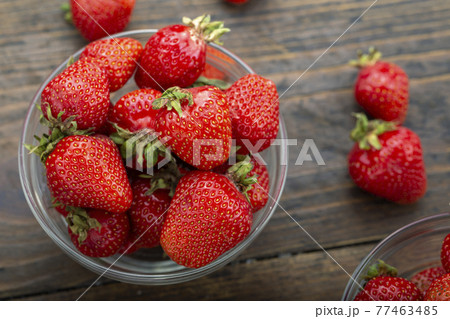 Ripe red strawberries on wooden table Ripe red strawberries on wooden table 77463485