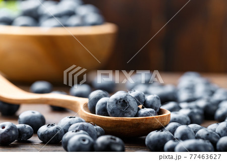 Juicy and fresh blueberries on a rustic table. Vegan and vegetarian concept. Juicy and fresh blueberries on a rustic table. Vegan and vegetarian concept. 77463627