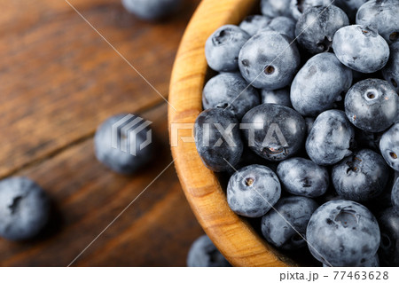 Juicy and fresh blueberries on a rustic table. Vegan and vegetarian concept. Juicy and fresh blueberries on a rustic table. Vegan and vegetarian concept. 77463628