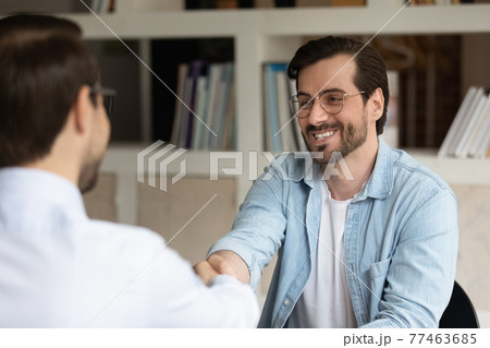 Hr manager shaking smiling man hand, congratulating successful candidate 77463685