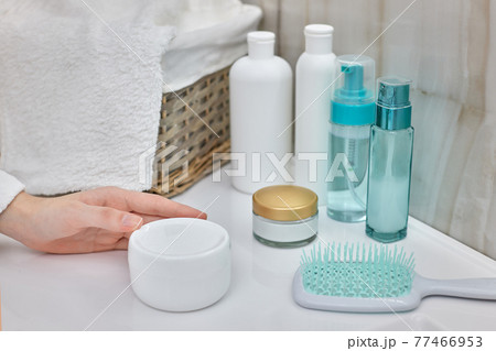 female hand holding jar with a cosmetic cream female hand holding jar with a cosmetic cream 77466953