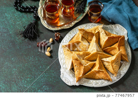 Arabic Cuisine. Ramadan Kareem Festive. Ramadan menu, arabian pancake katayef (katayev, qatayef) and dates, pistachio. Copy space. 77467957