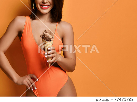 Woman hold chocolate ice-cream. Girl in sexy Woman hold chocolate ice-cream. Girl in sexy 77471738