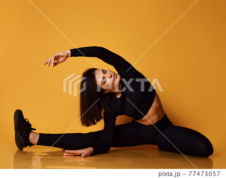 Young sexy pretty lady in black sportswear making 77473057