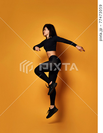 Young smiling sexy pretty lady in black sportswear 77473059
