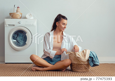 woman is doing laundry woman is doing laundry 77475393