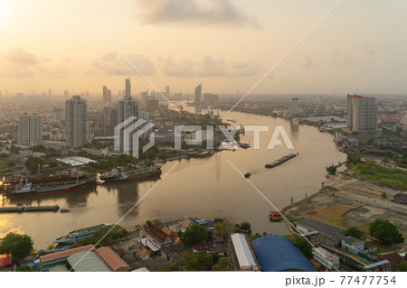 Aerial view of Bangkok City skyline by Chao Phraya River in Thailand. Financial district and skyscraper office buildings. Downtown skyline. Urban town at sunset. Aerial view of Bangkok City skyline by Chao Phraya River in Thailand. Financial district and skyscraper office buildings. Downtown skyline. Urban town at sunset. 77477754