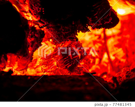 Burning firewood in rural oven. Red flame of wood stove in the dark. Cozy warm fireplace bonfire combustion at night. Burning firewood in rural oven. Red flame of wood stove in the dark. Cozy warm fireplace bonfire combustion at night. 77481345