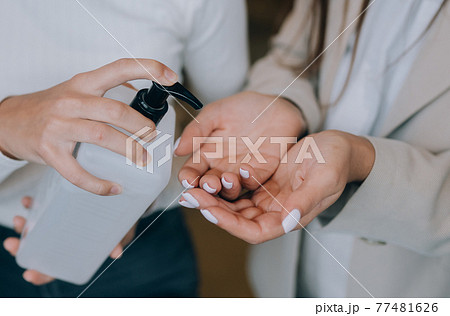 Female hands applying antibacterial liquid soap close up. 77481626