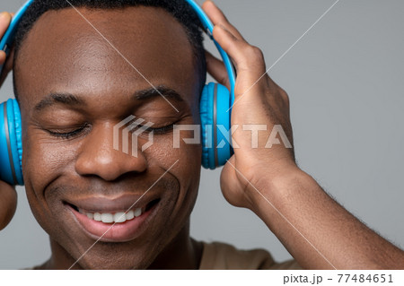 Satisfied face of african american in headphones 77484651