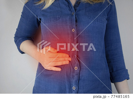 A woman grabs his right side under the ribs. Pain in the liver. Pain syndrome in liver disease. Hepatologist examination 77485165