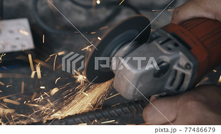 Worker man using electric wheel grinding and cutting on steel structure Worker man using electric wheel grinding and cutting on steel structure 77486679