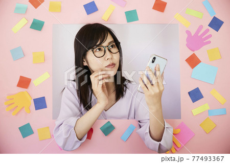 Woman with pink board. cell phone Woman with pink board. cell phone 77493367