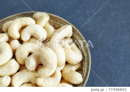 Cashew nuts in a bowl, selective focus, space for text. Cashew nuts in a bowl, selective focus, space for text. 77496602
