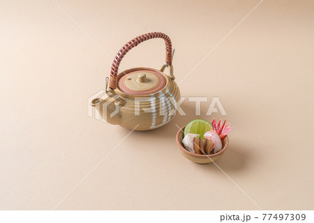 dobin mushi - steamed matsutake mushroom and pike conger with Japanese broth in an earthenware teapot. dobin mushi - steamed matsutake mushroom and pike conger with Japanese broth in an earthenware teapot. 77497309