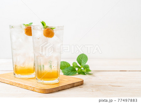 iced plum juice with soda and peppermint 77497883