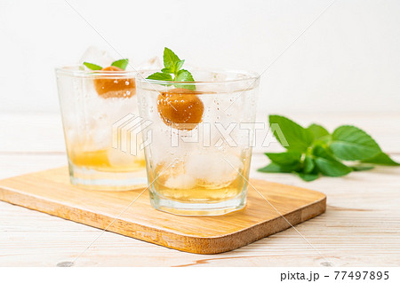 iced plum juice with soda and peppermint 77497895