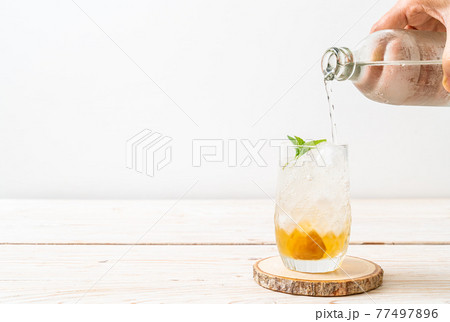 iced plum juice with soda and peppermint 77497896