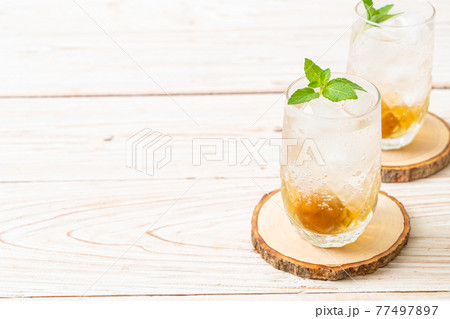 iced plum juice with soda and peppermint 77497897