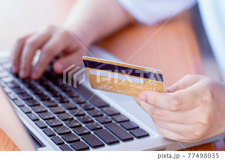 Online Payment . Woman hands holding credit card and using laptop. Online shopping 77498035