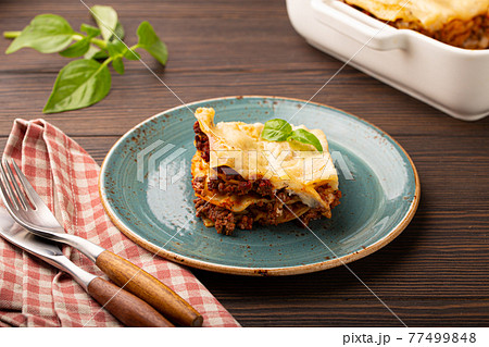 Traditional Italian lasagna on plate on wooden table 77499848