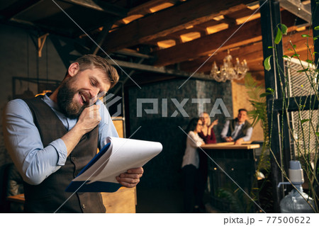 Man working in modern office using devices and gadgets during creative meeting Man working in modern office using devices and gadgets during creative meeting 77500622
