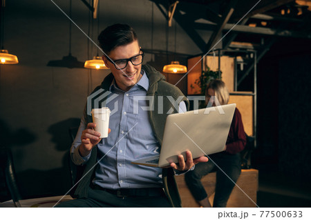 Man working in modern office using devices and gadgets during creative meeting 77500633