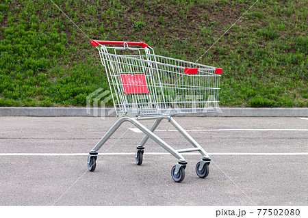 Empty shopping cart or trolley on suppermarket parking Empty shopping cart or trolley on suppermarket parking 77502080