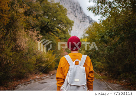 Outdoor fashion photo of young beautiful lady surrounded autumn forest in mountains Outdoor fashion photo of young beautiful lady surrounded autumn forest in mountains 77503113