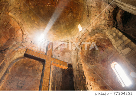 Mtskheta Georgia. Bottom View Of Big Wooden Cross On Stone Walls And Dome Background Of Jvari Church Mtskheta Georgia. Bottom View Of Big Wooden Cross On Stone Walls And Dome Background Of Jvari Church 77504253