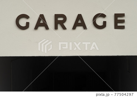 GARAGE written in capital letters on a white wall 77504297
