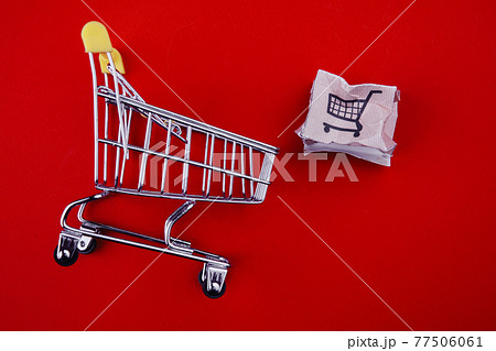 Shopping cart with spoiled box isolated on red. Delivery problem concept Shopping cart with spoiled box isolated on red. Delivery problem concept 77506061