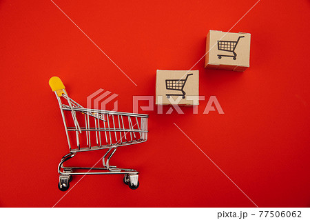 Shopping cart with boxes isolated on red Shopping cart with boxes isolated on red 77506062