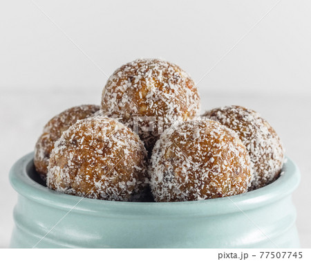 Homemade energy balls with dried apricots, raisins, walnuts, almonds and coconut. Healthy sweet food. Homemade energy balls with dried apricots, raisins, walnuts, almonds and coconut. Healthy sweet food. 77507745