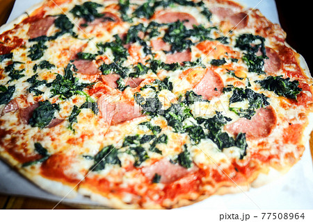 Homemade Pepperoni Pizza with tomatoes cheese and mushrooms on wooden table Homemade Pepperoni Pizza with tomatoes cheese and mushrooms on wooden table 77508964