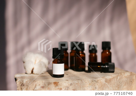 different cosmetics products on rock, Essential oils or face toner samples different cosmetics products on rock, Essential oils or face toner samples 77510740