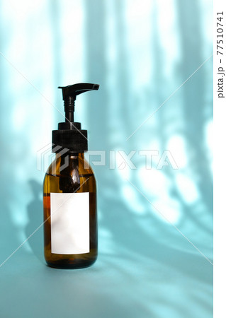 Natural skincare cosmetics, creams and oils on blue background. Plant-based beauty products. 77510741