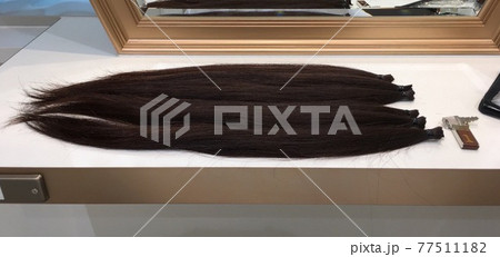 ヘアドネーション用にカットされた長いストレートヘア 77511182