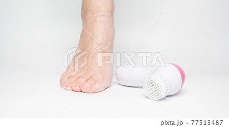 Beautiful barefoot female dry skin feet with a set of the pedicure tools Beautiful barefoot female dry skin feet with a set of the pedicure tools 77513487